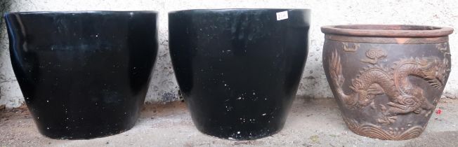 A pair of contemporary black glazed terracotta planters, 40cm high x 49cm diameter and another