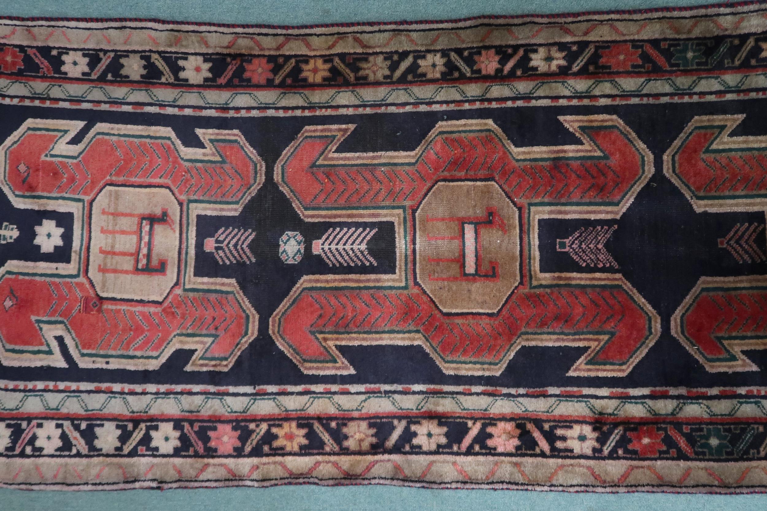 A dark ground Traditional Persian Meshkin runner with geometric medallion design decorated with - Image 4 of 4