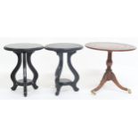 A lot comprising a pair of contemporary ebonised tables with tripod bases and a reproduction
