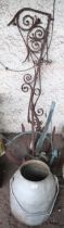 A mixed lot to include a cast iron boats anchor, wrought iron scrolled wall bracket, milk canister