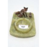 A cold painted spelter group of foxes, mounted on a onyx dish base Condition Report:Available upon