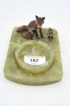 A cold painted spelter group of foxes, mounted on a onyx dish base Condition Report:Available upon