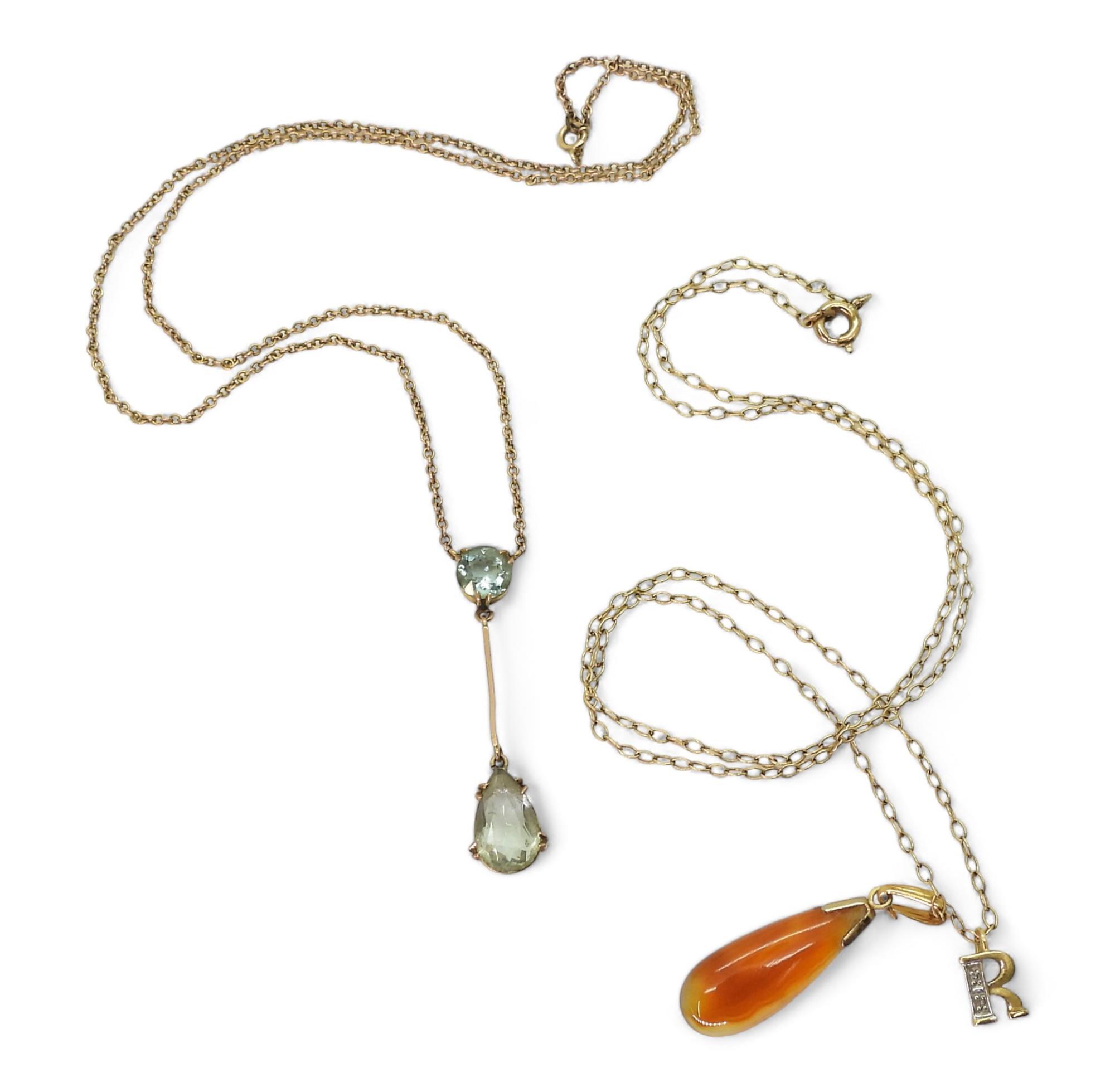 An 18ct and diamond 'R' pendant, weight 0.5gms,  9ct gold aquamarine pendant necklace, and a 9ct