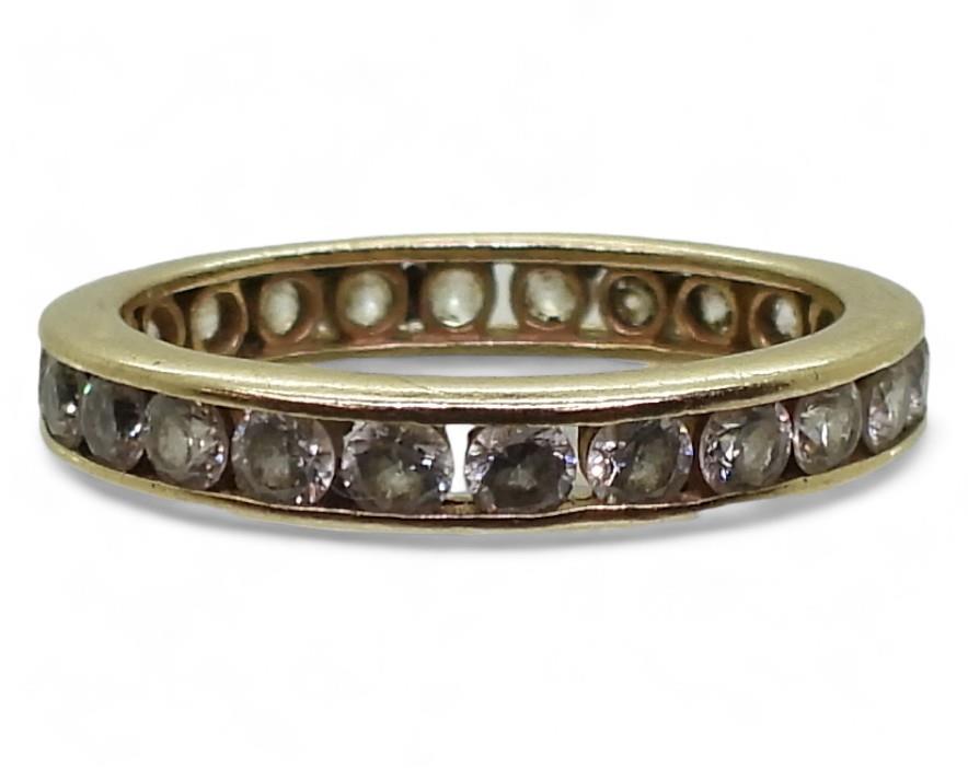 A 14k gold full eternity ring set with cubic zirconia, finger size O, weight 2.8gms Condition