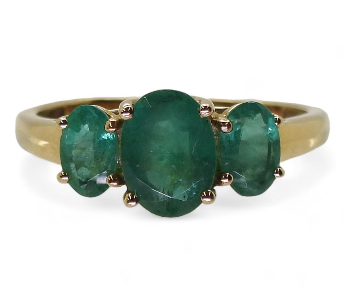 A 9ct gold emerald three stone ring, size T, weight 2.4gms Condition Report:Available upon request