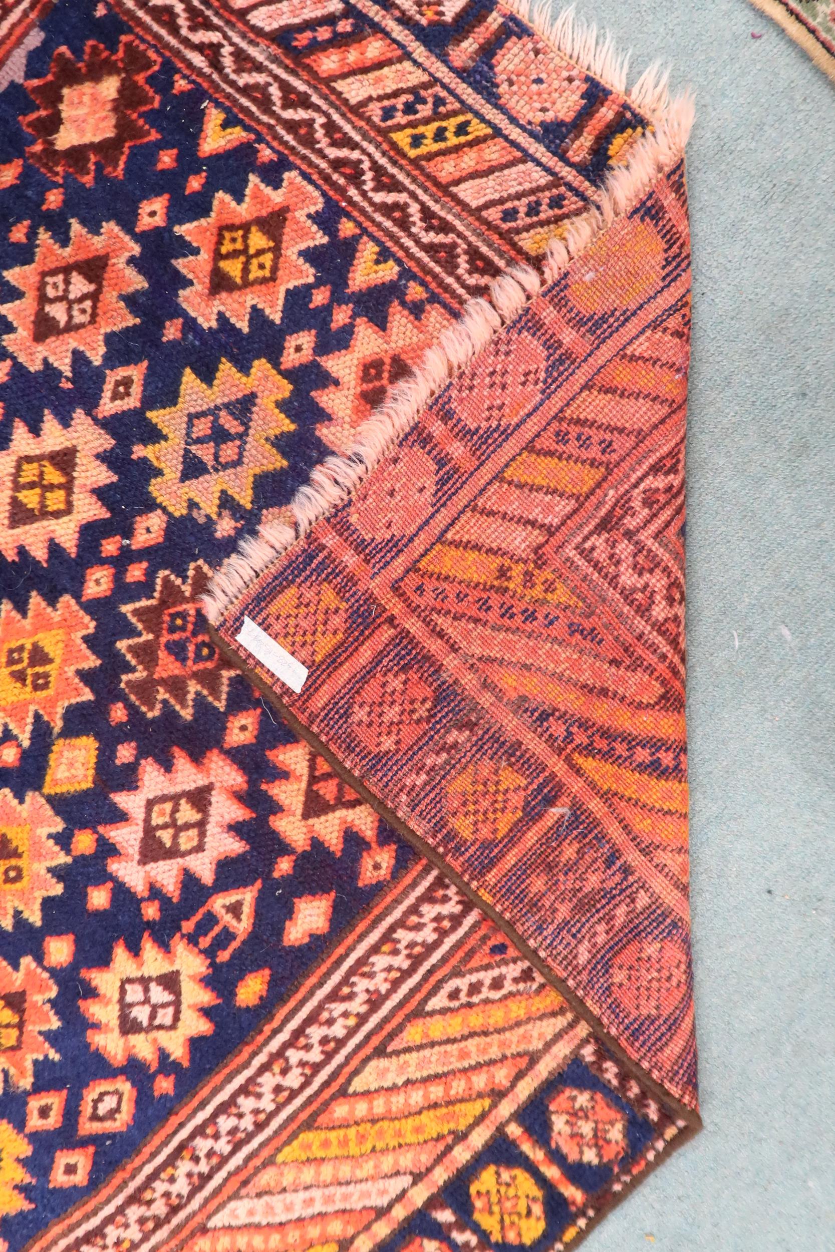 A dark blue ground Persian Qashqai rug with burnt orange geometric pattern within burnt orange - Image 2 of 3