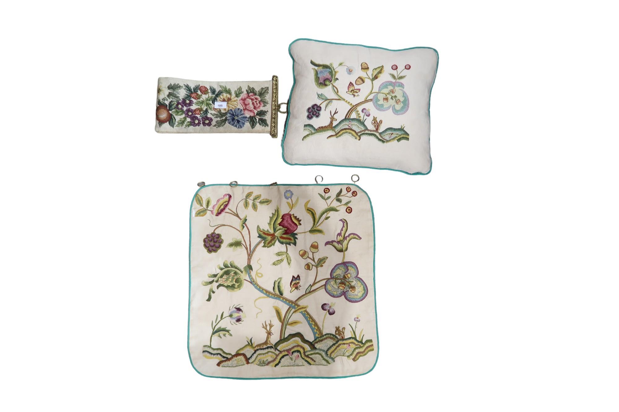 A crewel work cushion and matching wall hanging together with an embroidered tapestry panel