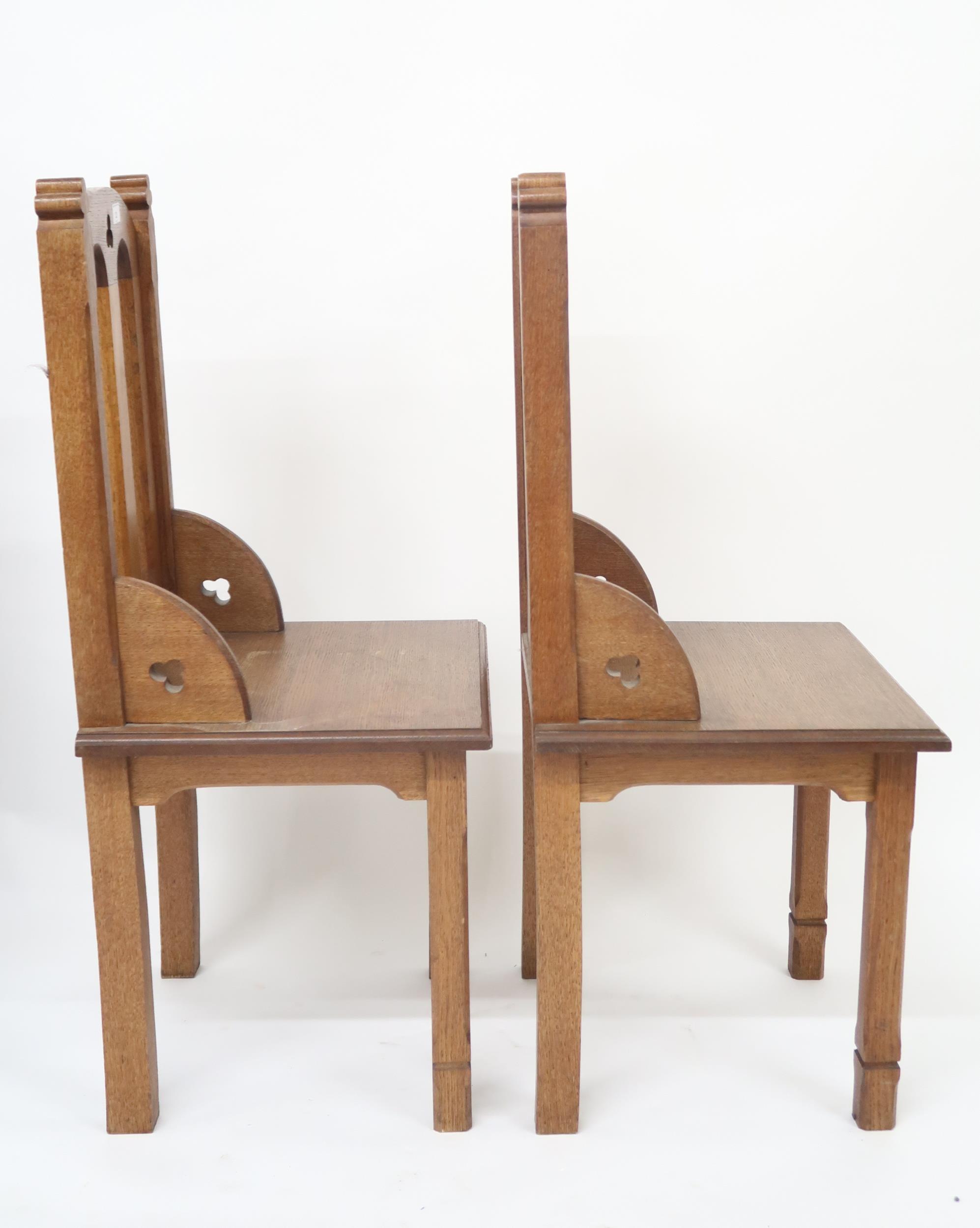 A pair of early 20th century oak ecclesiastical style chairs with pierced trefoil decorations on - Image 2 of 2