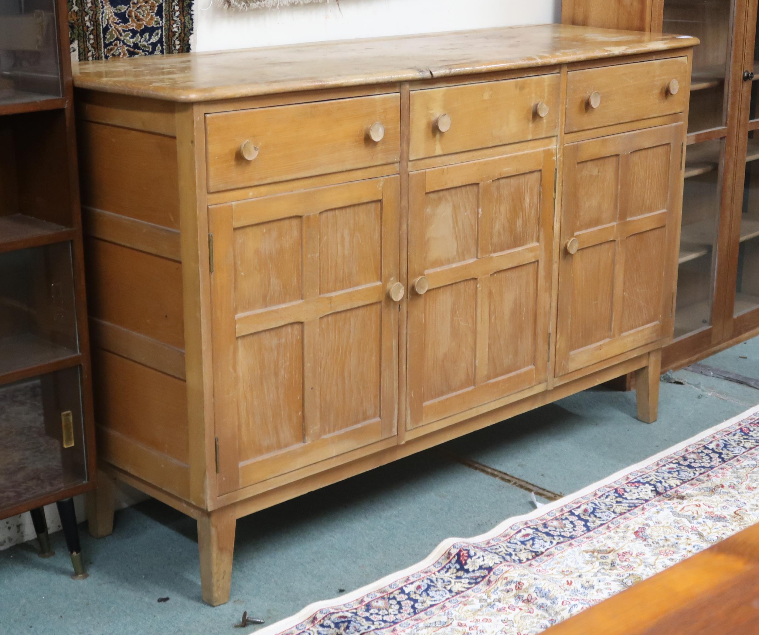 A mid 20th century elm and beech Ercol style sideboard with shaped top over three short drawers over - Image 2 of 3