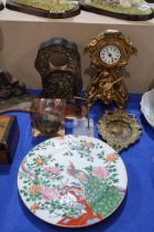 A gilded Art Nouveau clock, a silvered front clock case, a rock crystal watch stand, a wooden