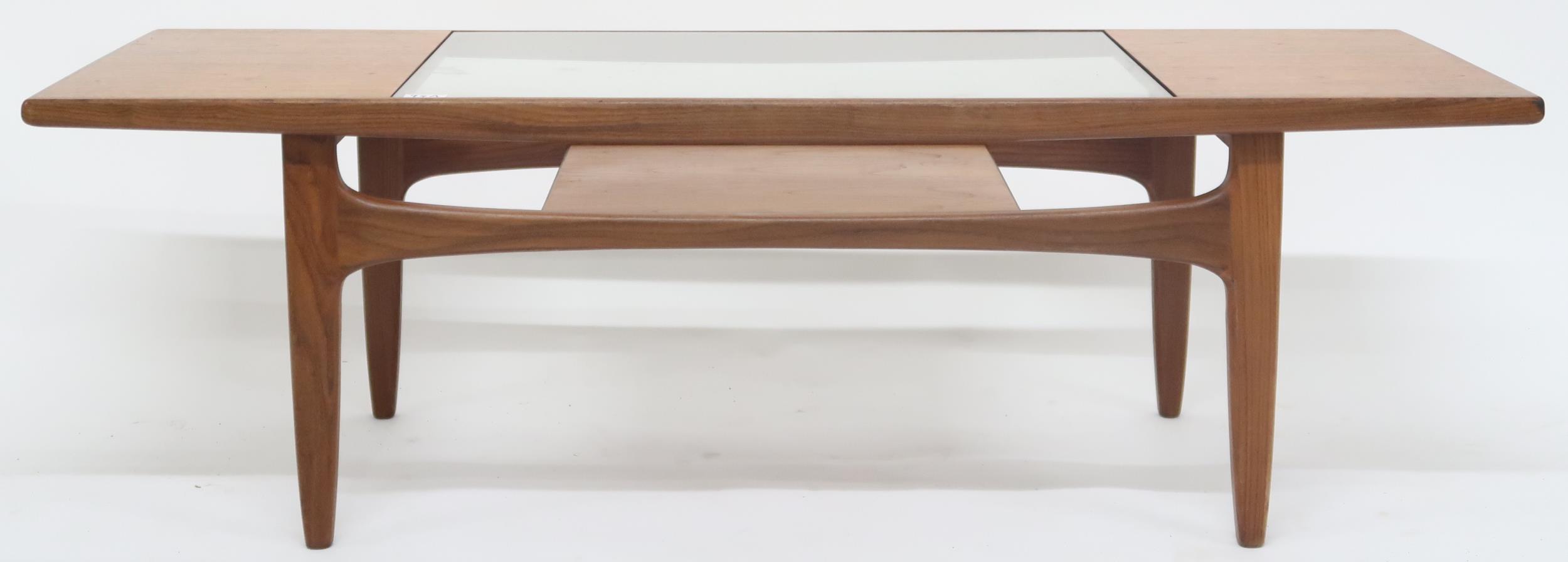 A mid 20th century G Plan teak glass topped coffee table with shaped supports joined by lower