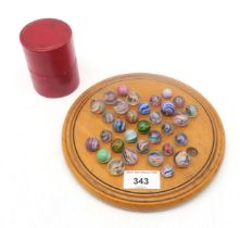 A small German solitaire board, measuring approx. 19.5cm in diameter, with a collection of