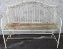 A 20th century yellow painted metallic garden bench with wire work back and sides over slatted seat,