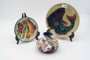 Three Moorcroft fish decorated pieces including a 1989 year plate, a smaller plate and a vase