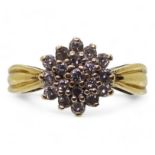An 18ct gold diamond cluster ring, set with estimated approx 0.50cts of brilliant cut diamonds,