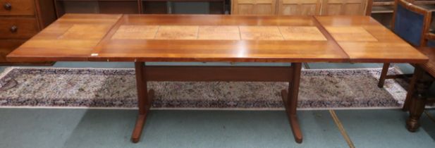 A mid 20th century Scandinavian Skovby teak tile topped extending dining table with drop ends on