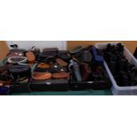 A quantity of binoculars with various makers and models with Nikon, Pentax, E. Leitz, Carl Zeiss,