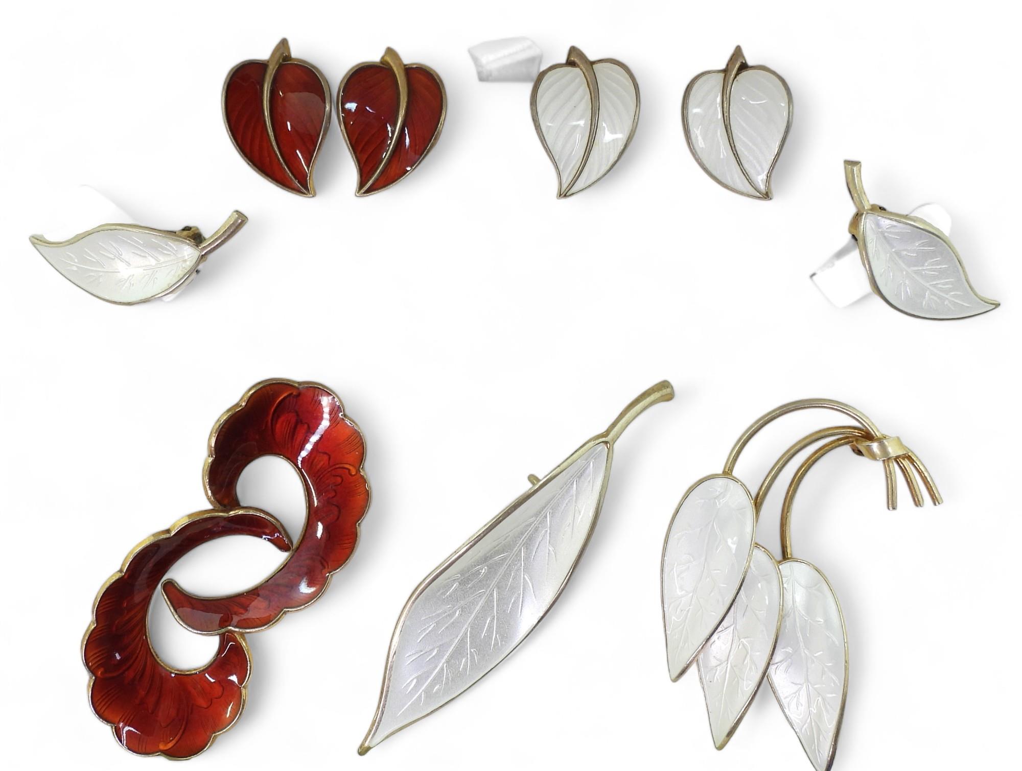 A collection of silver gilt  Norwegian enamel jewellery to include a white leaf brooch and