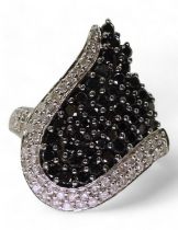 A 9ct white gold black and white diamond statement ring, size O, weight 7.2gms Condition Report: