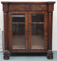 A 19th century mahogany and walnut veneered pier cabinet with two short frieze drawers over pair
