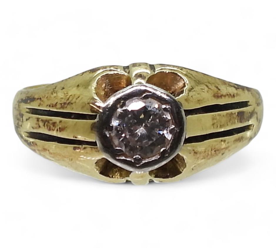 An 18ct gold and platinum solitaire diamond gypsy ring, set with an estimated approx 0.50ct