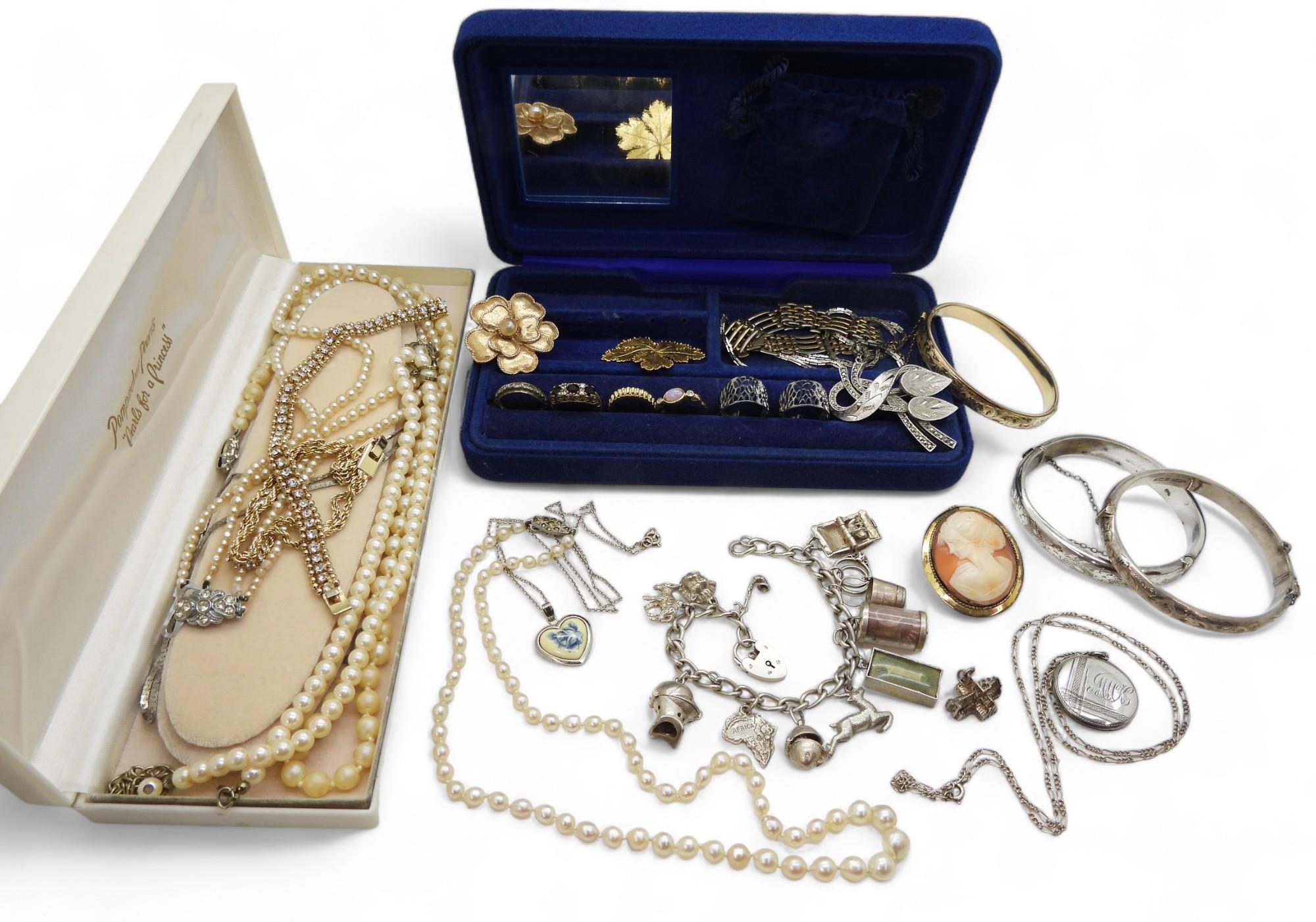 A collection of silver jewellery to include silver bangles, a charm bracelet, baroque pearl