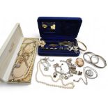 A collection of silver jewellery to include silver bangles, a charm bracelet, baroque pearl