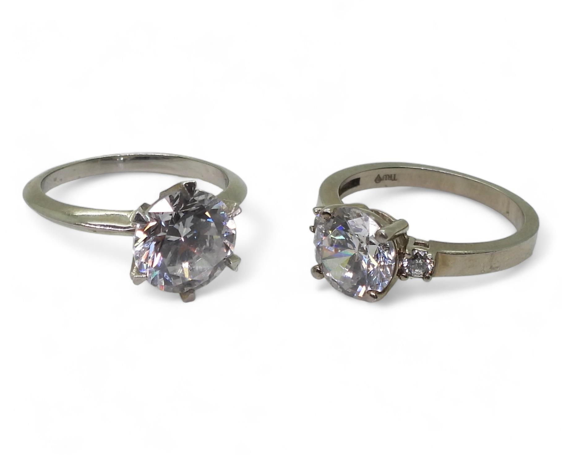 Two white metal mounted 'Tru Diamonds' diamond simulant rings, a solitaire size M1/2, ans a three