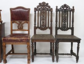 A lot comprising two assorted 19th century provincial oak hall chairs with carved backrests on
