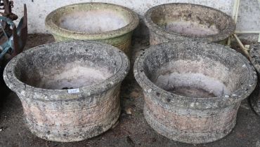 A lot of four 20th century reconstituted stone "Willowstone" circular garden planters with floral