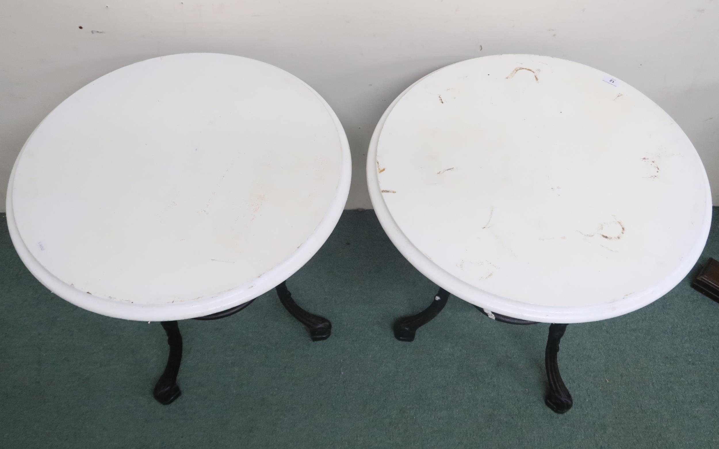 A pair of late 19th/ early 20th century pub/bar tables with painted circular tops on cast iron bases - Image 3 of 3
