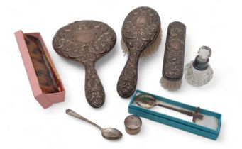 A silver dressing set, with mask decoration, a stamped sterling spoon, an EPNS spoon, a silverpill