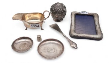 A silver cream jug, by Martin Hall & Co, Sheffield, a silver photo frame, a Dorcas thimble, two