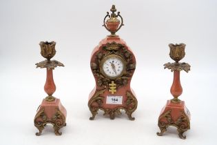 A peach marble clock garniture with Swiss movement, clock 27cm high Condition Report:Available