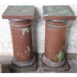 A pair of 20th century stoneware garden pedestals with square tops on cylindrical columns on