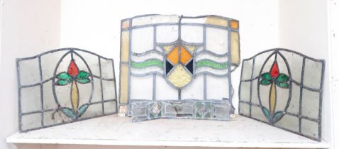 A lot comprising a pair of leaded stained glass panels another larger stained glass panel and