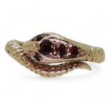 A 9ct gold snake ring, set with garnets, size Q, London 1973 hallmarks  weight 3.9gms Condition
