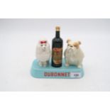 A Beswick Dubonnet advertising model  of a bottle flanked by Poodle and Bulldog on blue base