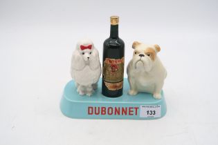 A Beswick Dubonnet advertising model  of a bottle flanked by Poodle and Bulldog on blue base