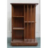 An early 20th century mahogany revolving bookcase with square top over asymmetrical shelves with