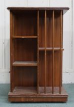 An early 20th century mahogany revolving bookcase with square top over asymmetrical shelves with