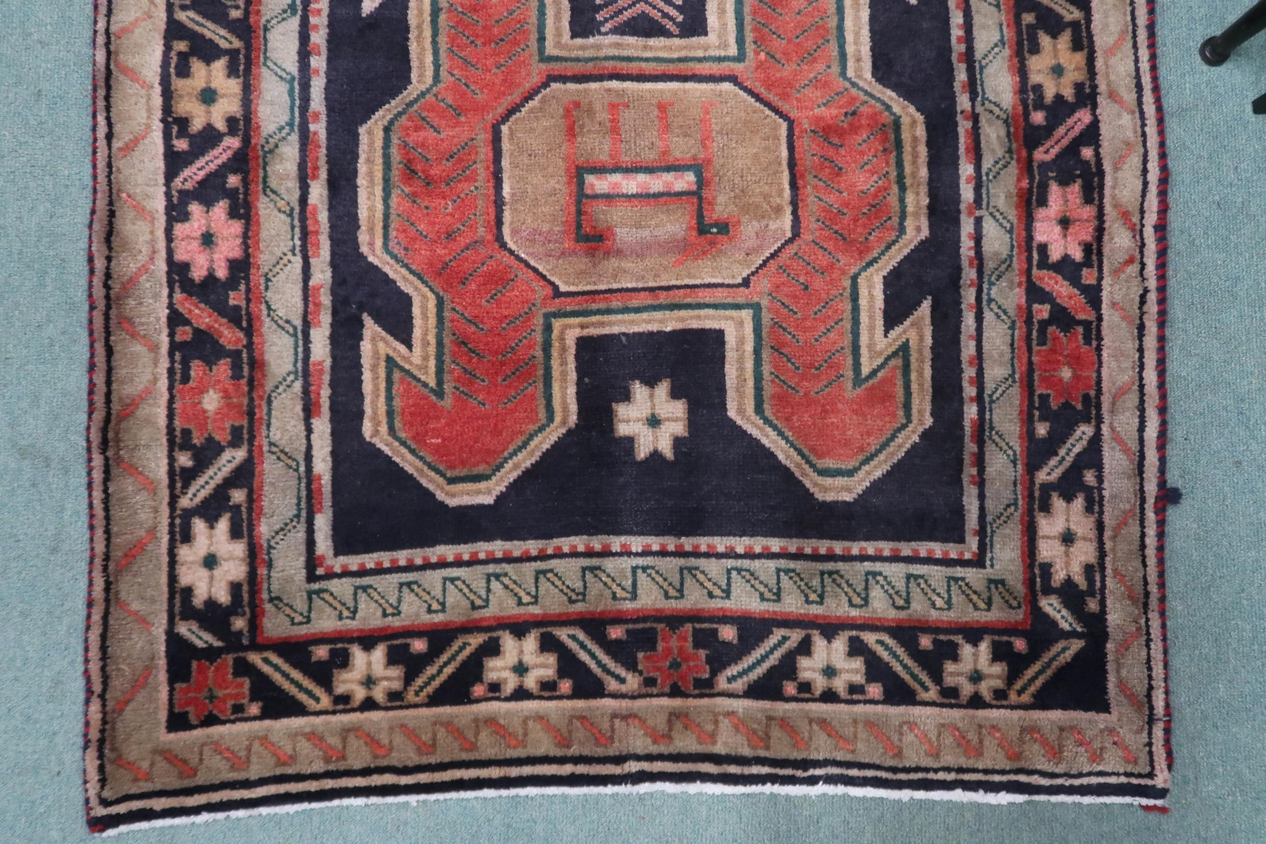 A dark ground Traditional Persian Meshkin runner with geometric medallion design decorated with - Image 2 of 4