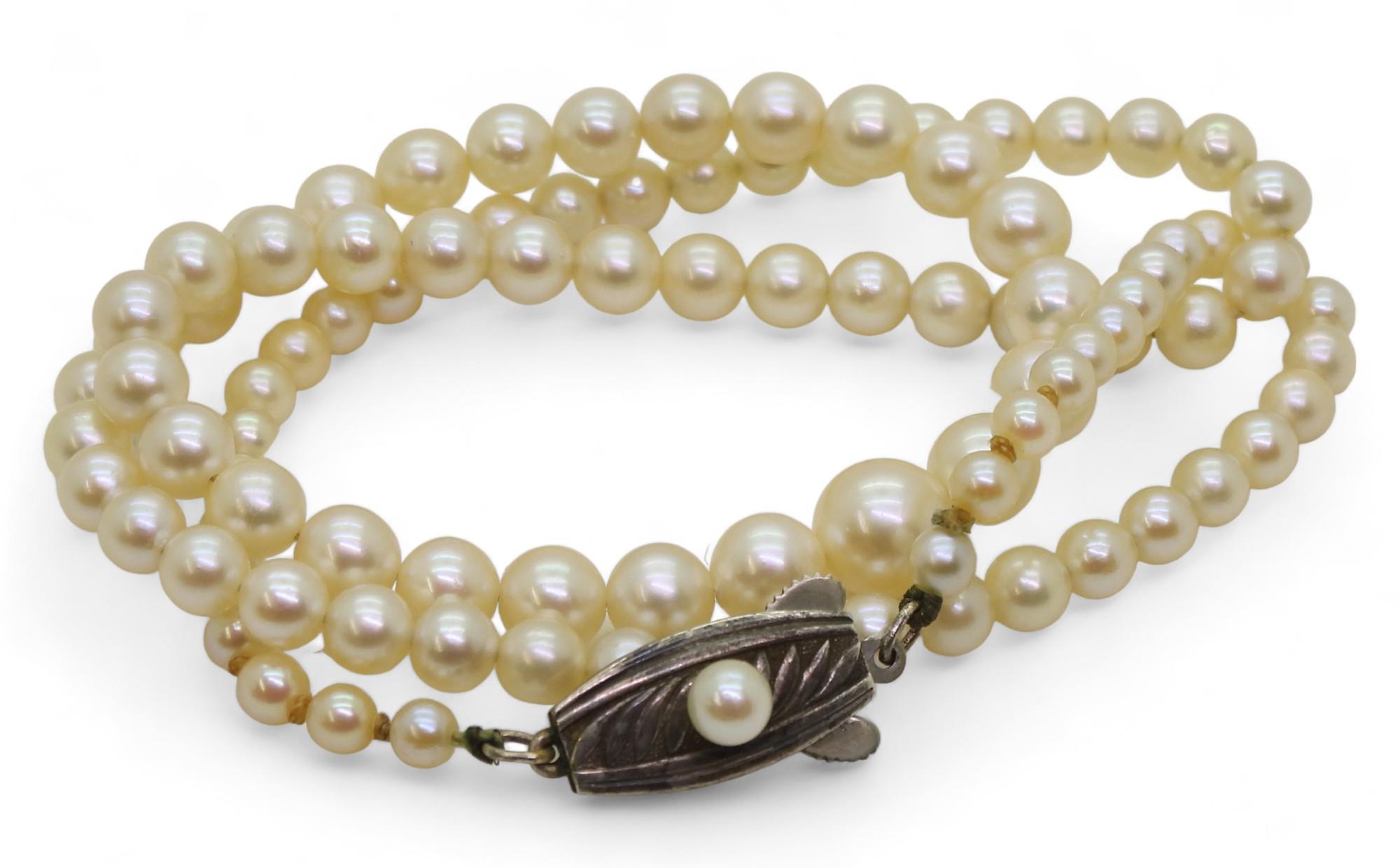 A 46cm string of Mikimoto pearls with silver pearl set Mikimoto branded clasp, in original box