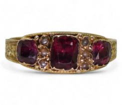 An 18ct gold Victorian garnet and pearl ring, size R, weight 2.1gms Condition Report:Available