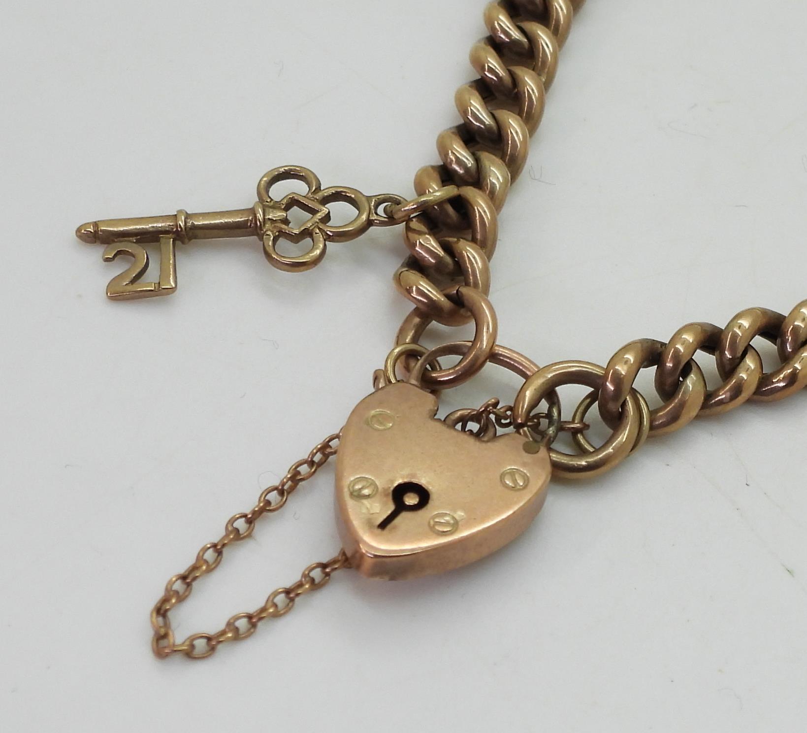 A 9c tapered curb chain bracelet, with heart shaped clasp, and 21st key charm, length 18cm, weight - Image 2 of 2