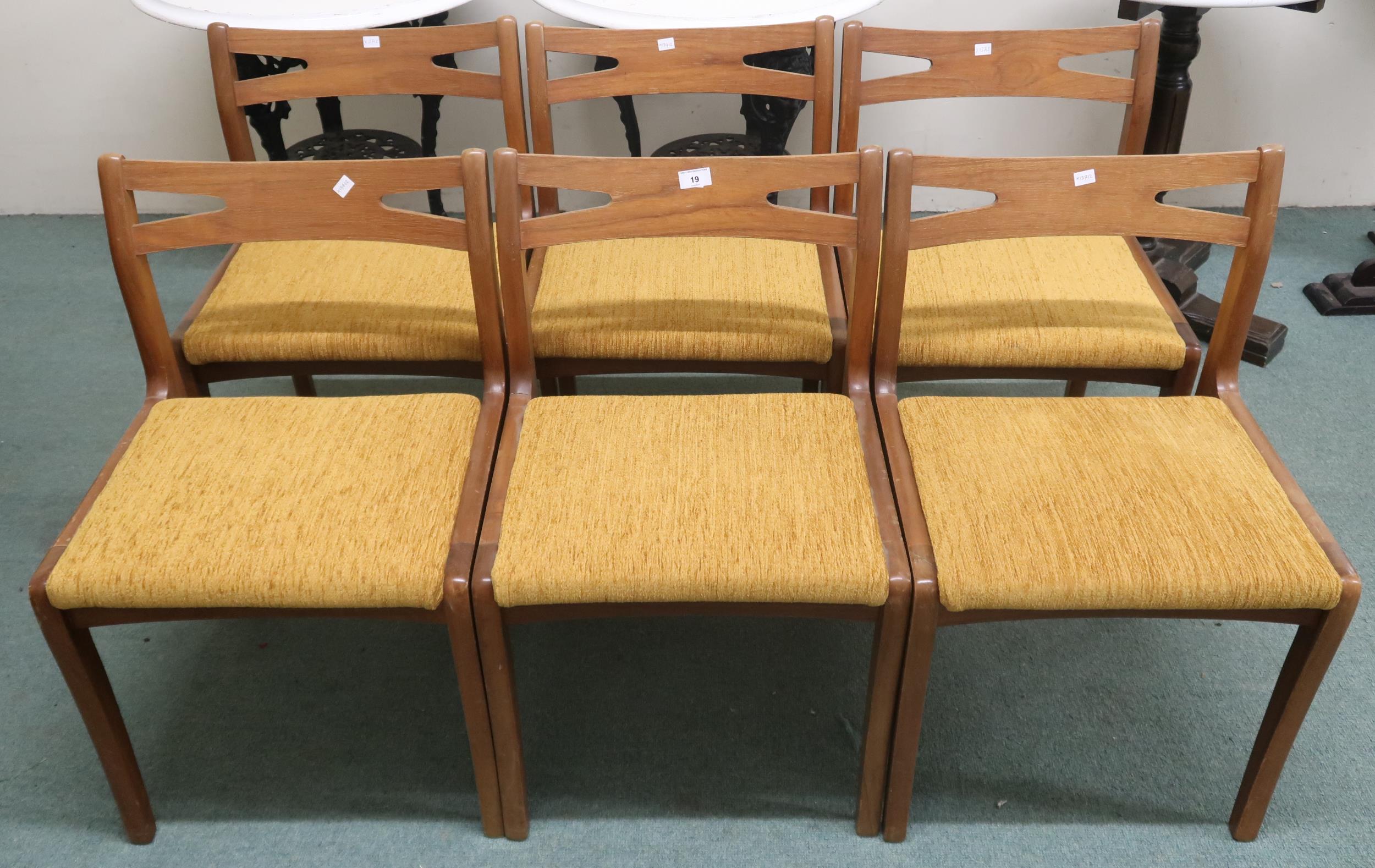 A set of six mid 20th century teak Nathan dining chairs with shaped pierced splats over