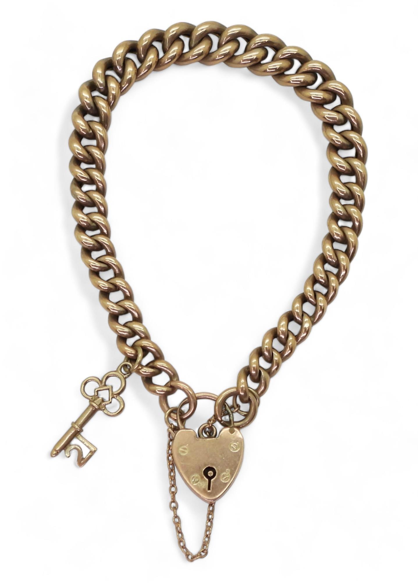 A 9c tapered curb chain bracelet, with heart shaped clasp, and 21st key charm, length 18cm, weight