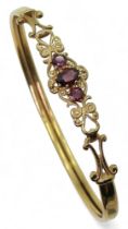 A 9ct gold garnet set bangle, inner diameter approx 5cm, weight 5.7gms Condition Report:Available