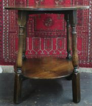 A 20th century oak G.T. Rackstraw, Worcester circular topped two tier occasional table with turned