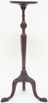 A 20th century mahogany circular topped jardiniere stand with turned octagonal column support on